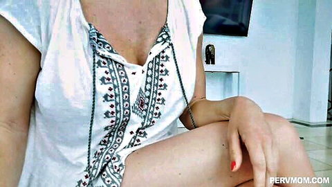 Krissy Lynn in low-cut embroidered white top showing deep cleavage