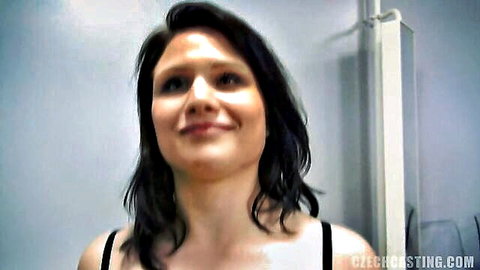 Amateur brunette smiling in casting audition, wearing black tank top