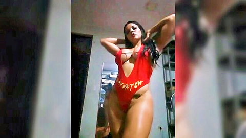 Curvy Latina in sexy red Baywatch swimsuit showing deep cleavage and thick thighs