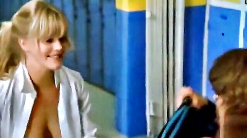 Blonde pigtail girl flashes huge bare tits in open shirt smiling at guy in locker room