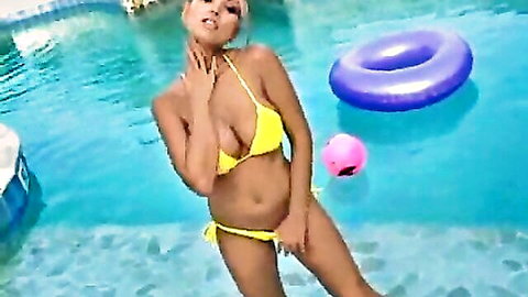Anette Dawn in sexy yellow bikini posing by the pool, busty blonde beauty