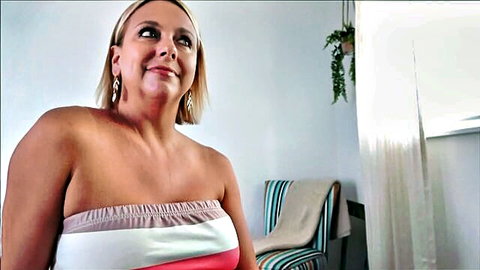 Busty blonde Brianna Beach smiling in tight tube top, showing cleavage