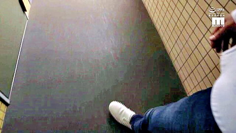 Big pale ass exposed with jeans pulled down to white sneakers in tiled bathroom stall