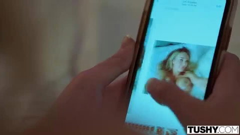 Gabbie Carter fingers her ass on phone screen in Tushy closeup