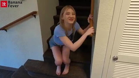Melody Marks squatting barefoot on stairs in tight top and shorts