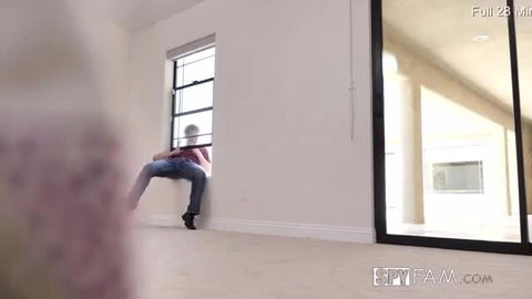 Mira Stone in jeans squats teasingly by window in hot stepsis scene