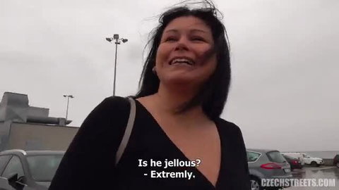 Busty married Asian MILF smiles in car park, black dress, asks if he's jealous