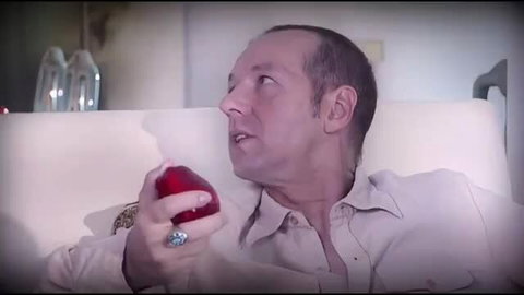 Katsumi holding red apple topless, perky tits, seductive pose