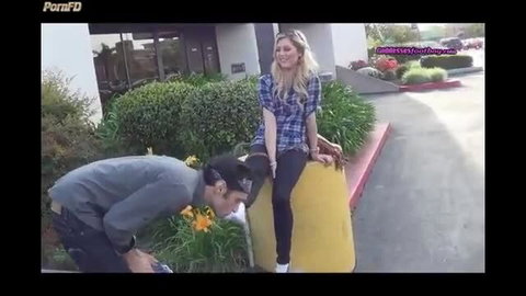 Blonde teen in plaid shirt and jeans gets public foot worship from kneeling guy