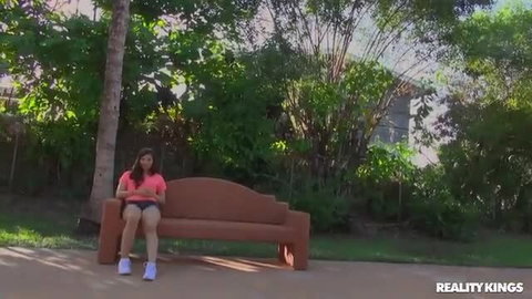 Nina Turk in pink top and shorts on park bench, Reality Kings