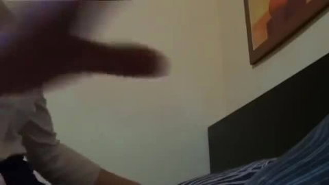 Blurry closeup of erect penis in hand during night sex ed session