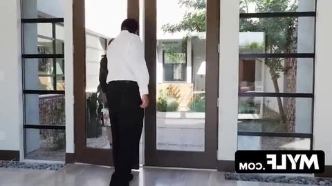 Hot MILF in white shirt black pants at door with teen in adult video