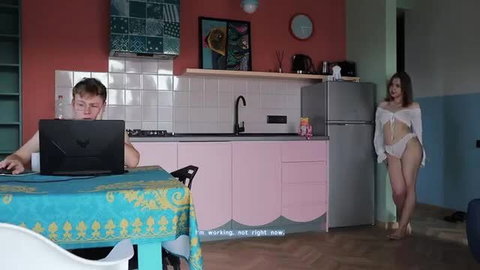 Amateur brunette in lingerie teases guy working on laptop in kitchen