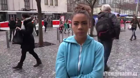 Mixed-race girl in hoodie arms crossed at bus stop outdoor public