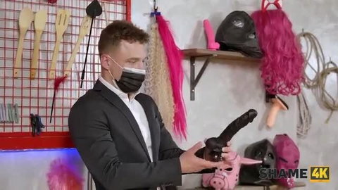 Tanya Virago holds huge dildo in kinky BDSM setup