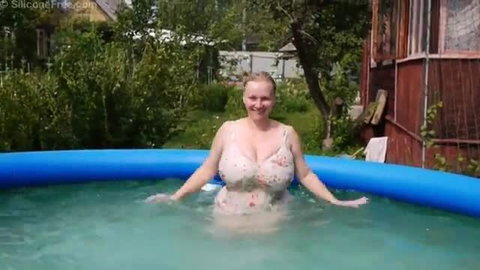 Busty blonde in wet dress enjoys homemade orgasm in outdoor pool