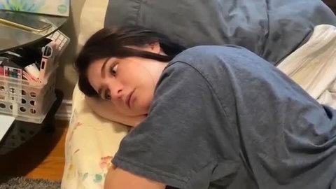 POV stepsis lying sideways on bed in tight t-shirt, seductive gaze
