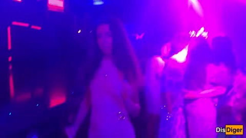 Hot brunette dancing in tight white dress at neon nightclub party