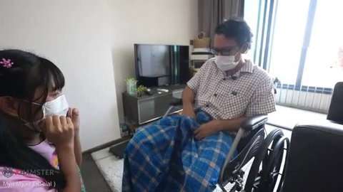Old Myanmar man in wheelchair with young Asian stepdaughter