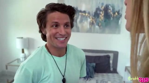 Haley Reed smiles playfully in bed with male partner