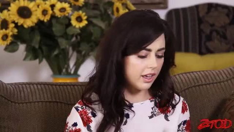 Ann Wright brunette in floral dress on couch in Zero Tolerance threesome