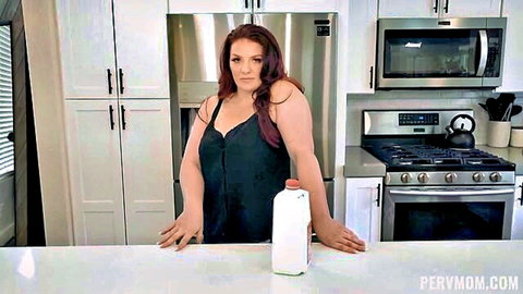 Emmy Demure as curvy redhead stepmom in black dress holding milk jug, huge boobs tease