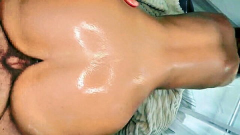 Oiled big ass close-up from behind, ready for hard anal fuck