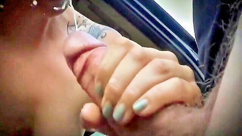 Tattooed woman in glasses giving intense car blowjob