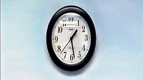 Black analog clock showing 10:19 on light blue background