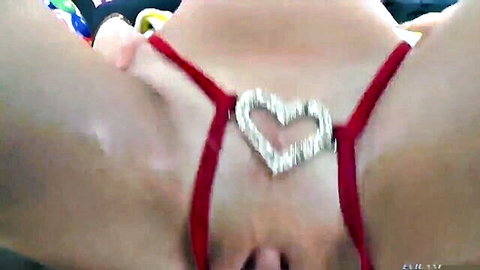 Close-up of shaved pussy in red crotchless lingerie with diamond heart