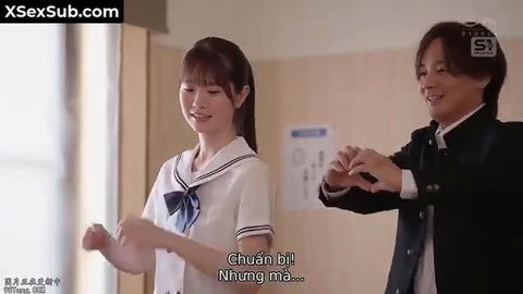Asian schoolgirl in sailor uniform holds hands with smiling guy in JAV classroom tease
