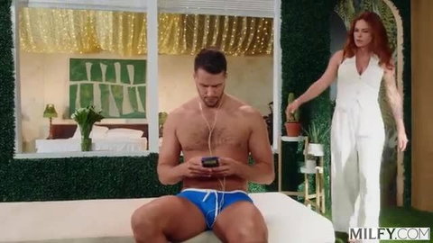 Redhead Molly Manning in white jumpsuit eyes topless hunk in blue speedo