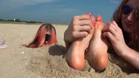 TickleIntensive redhead tickles buried girl's bare soles on beach