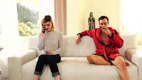 Trans Ella Hollywood in striped top and jeans on couch with man