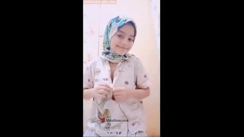 Cute Asian Muslim teen in hijab teases big tits in unbuttoned top