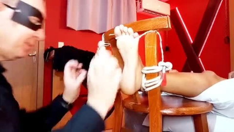 Brazilian babe tied to chair, bare feet tickled by Mask Guy