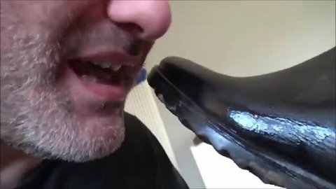 Gabriella forces man to lick mud off her shiny black flat boots