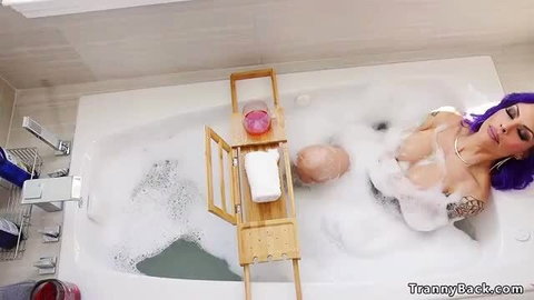 Busty Ts Foxxy soaks in bubbly bath, wet curves exposed