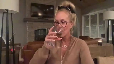 Brandi Love granny sips wine in cozy sweater livestream