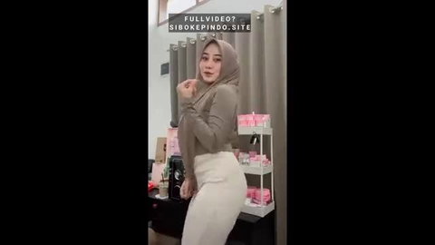 Curvy Indonesian hijab girl in tight pants posing sexy
