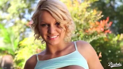 Curvy blonde babe in tight tank top smiles outdoors in Diabolic scene