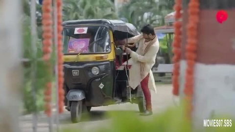 Indian housewife in white sherwani red churidar by black auto rickshaw