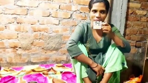 Desi Indian Bhabhi sipping chai in green salwar kameez, teasing homemade chudai