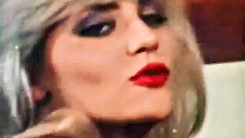 Blonde bombshell with red lips pouting seductively for blowjob tease closeup