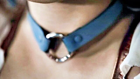 Superheroine in blue BDSM collar during torture scene