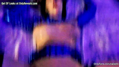 Blurry brunette amateur solo with open mouth and exposed tits in purple light