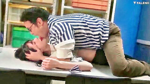 Passionate Japanese couple kissing intensely on desk, woman topless midriff exposed
