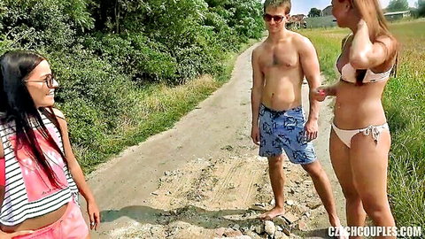 Skinny brunette in tiny shorts flirts with shirtless guy and blonde in skimpy bikini on public Czech path