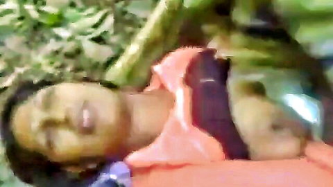 Sri Lankan woman lying in jungle foliage, outdoor amateur scene
