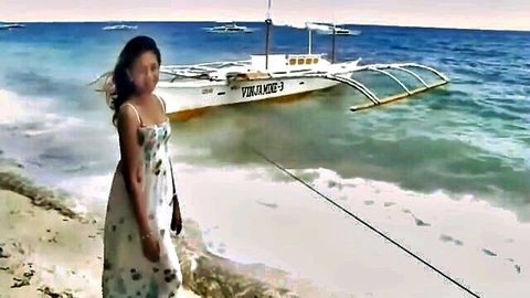 Stunning Filipino ladyboy in flowing white dress on tropical beach